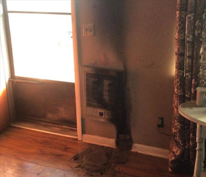 Living room heater blackened with soot and smoke damage