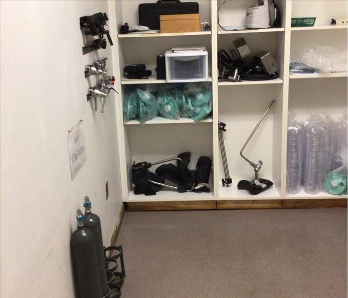 A closet with hospital equipment such as oxygen tanks, and other medical equipment. 
