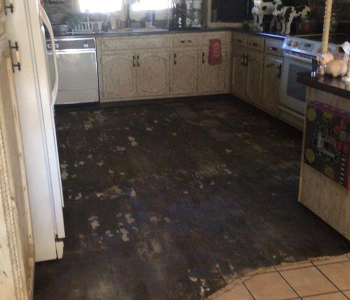 View of kitchen with hardwood flooring torn out
